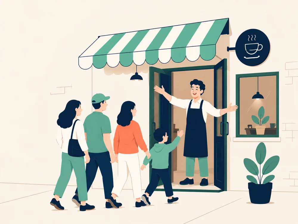 A waiter welcomes several customers at the café door.